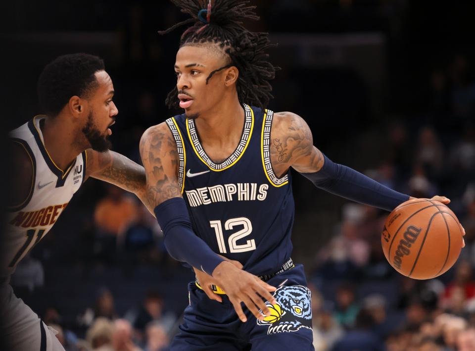 Memphis Grizzlies guard Ja Morant probes the defense of Denver Nuggets guard Monte Morris during their game at FedExForum on Wednesday, Nov. 3, 2021.