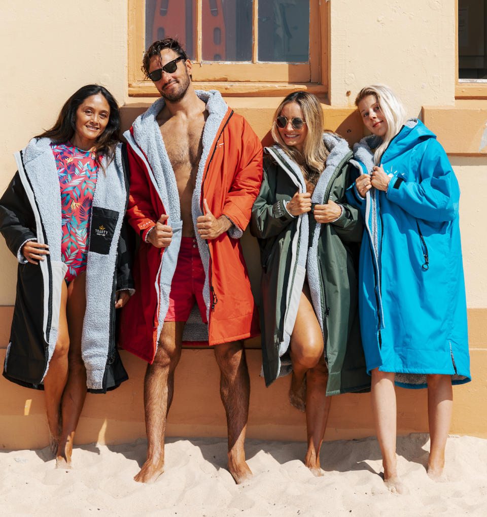 Four models wearing bathing suits and Toasty jackets