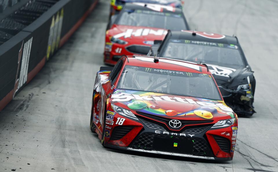 Kyle Busch leads Trevor Bayne and Kurt Busch (41) during a NASCAR Cup Series auto race, Monday, April 16, 2018, in Bristol, Tenn. Kyle Busch won the rain-delayed race. (AP Photo/Wade Payne)