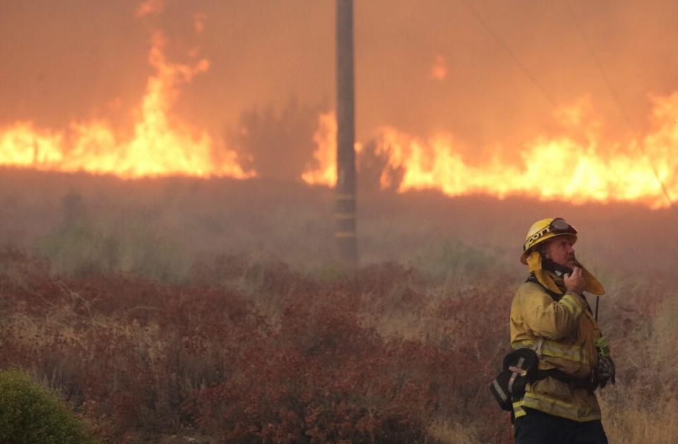 A firefighter works near flames as the Bobcat Fire burns on September 18, 2020 in Juniper Hills, California. Numerous homes were destroyed in the area a day after mandatory evacuations there as the Bobcat Fire has now scorched more than 72,000 acres. California’s national forests remain closed due to wildfires which have burned a record 3.4 million acres this year. (Photo by Mario Tama/Getty Images)