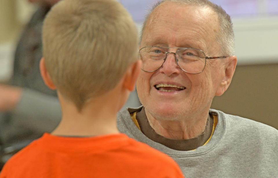 Keith Baiser enjoys a spirited conversation with second-grader Jackson Munsil on Thursday when Munsil's class from Sherman Elementary visited Dayspring and entertained the residents with Christmas carols.