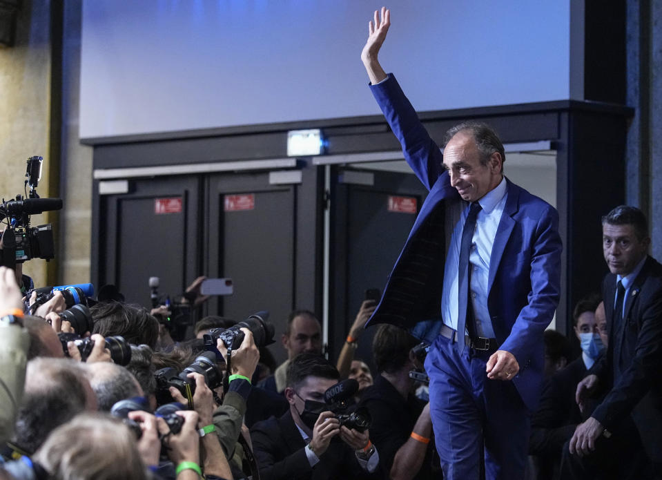 FILE - Far-right political talk-show star Eric Zemmour acknowledges applauses as he arrived on stage during a meeting to promote his latest book "La France n'a pas dit son dernier mot" (France has not yet said its last word) in Versailles, west of Paris, Oct. 19, 2021. A far-right former TV pundit with multiple hate-speech convictions is poised to officially enter the race for France's presidency, having already shaken it up with his anti-immigration, anti-Islam invective. (AP Photo/Michel Euler, File)