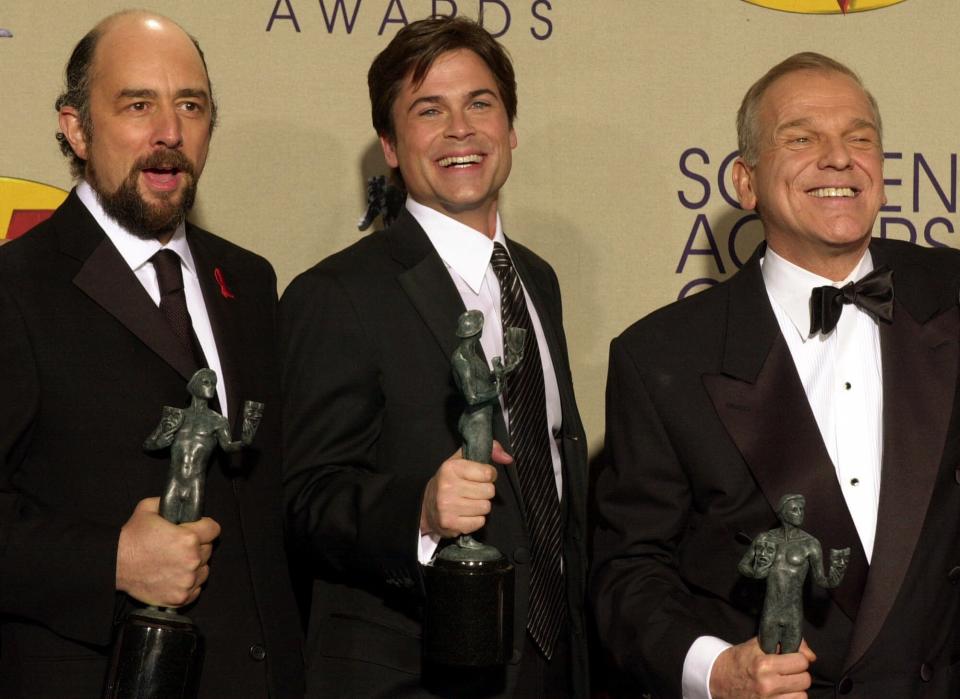 Members of the cast of "The West Wing" from left: Richard Schiff, Rob Lowe and John Spencer hold their awards for outstanding performance by an ensemble in a drama series at the 7th annual Screen Actors Guild Awards, Sunday, March 11, 2001, in Los Angeles. (AP Photo/Michael Caulfield)