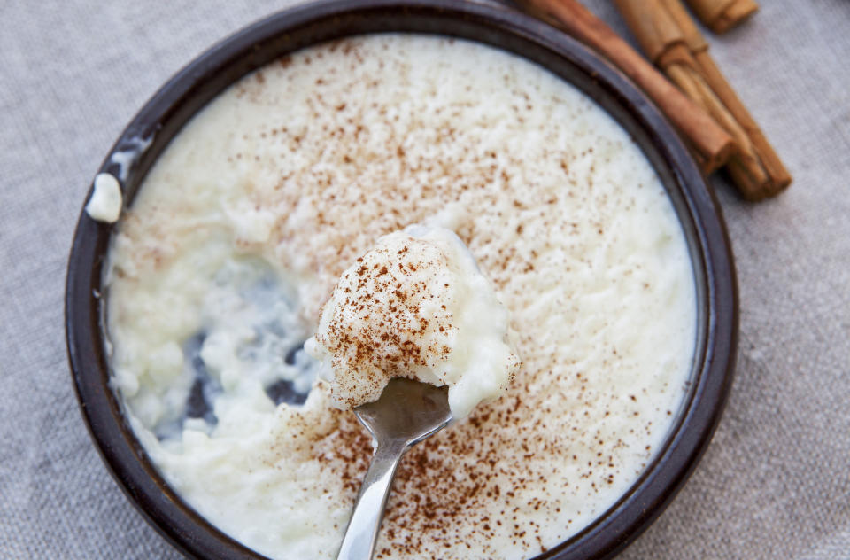 A bowl of rice pudding with cinnamon.