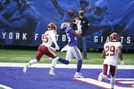 New York Giants' Darius Slayton catches a pass for a touchdown in front of Washington Football Team's Fabian Moreau (25) and Kendall Fuller (29) during the first half of an NFL football game Sunday, Oct. 18, 2020, in East Rutherford, N.J. (AP Photo/John Minchillo)