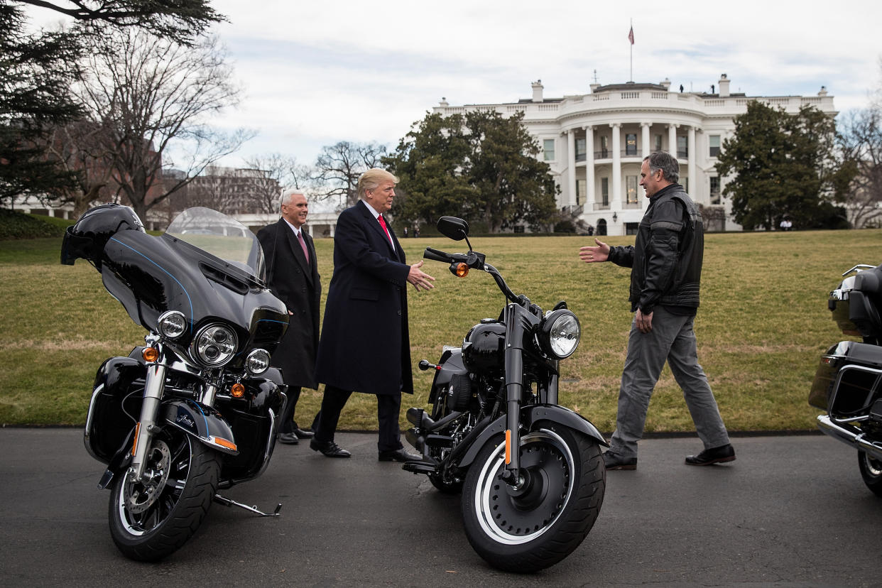 President Donald Trump (center) greets Matthew Levatich (right), CEO of Harley-Davidson Inc., outside the White House in February 2017 as Vice President Mike Pence smiles. (Photo: Drew Angerer/Bloomberg via Getty Images)