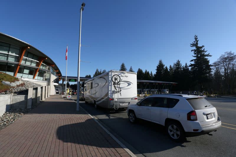 FILE PHOTO: Drivers wait to enter Canadian customs at Canada-US border crossing at Peace Arch park in Surrey