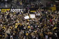 Fans storm the field after Appalachian State defeats Coastal Carolina after an NCAA college football game on Wednesday, Oct. 20, 2021, in Boone, N.C. (AP Photo/Matt Kelley)