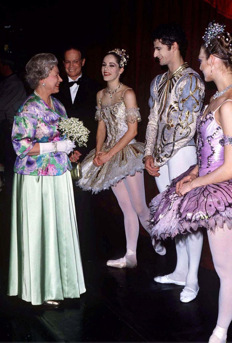 <p>The Queen visits with dancers from "Sleeping Beauty" at the Royal Opera House in 1996.</p>