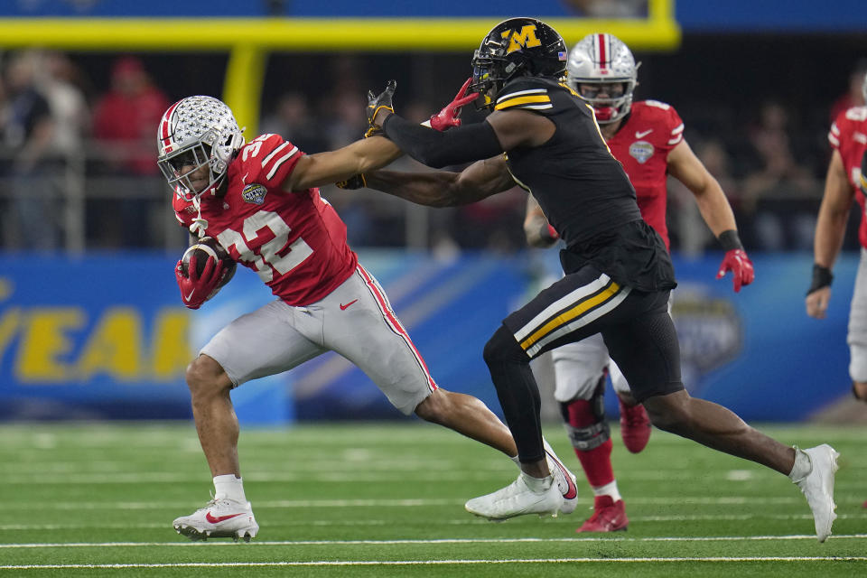 Ohio State running back TreVeyon Henderson (32) runs against Missouri defensive back Jaylon Carlies during the first half of the Cotton Bowl NCAA college football game Friday, Dec. 29, 2023, in Arlington, Texas. (AP Photo/Julio Cortez)