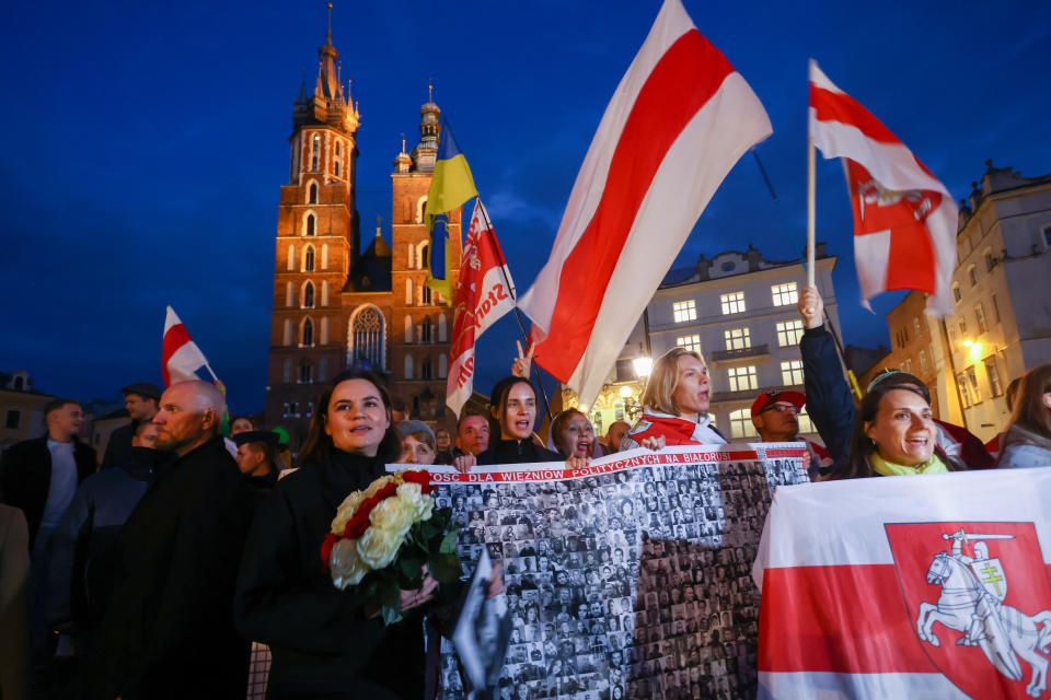 Tsikhanouskaya, holding a banner, takes part in a demonstration of solidarity with Belarus in Krakow, Poland,