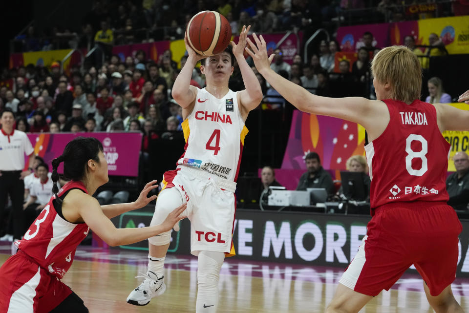 Japan's Mai Yamamoto, left, and Maki Takada right, attempt to block a shot from China's Yuan Li during the Asia Cup women's basketball final in Sydney, Australia, Sunday, July 2, 2023. (AP Photo/Mark Baker)