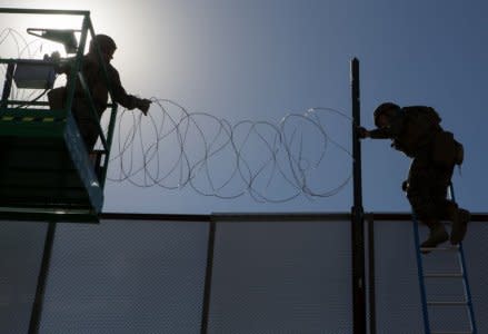 U.S. Marines with 7th Engineer Support Battalion, Special Purpose Marine Air-Ground Task Force 7, secure concertina wire along the California-Mexico border at the Otay Mesa Port of Entry in California, U.S., November 12, 2018.  U.S. Marine Corps/ Cpl. Cutler Brice/Handout via REUTERS