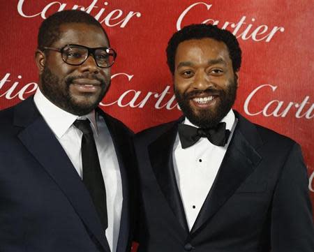 British film director Steve McQueen (L) poses backstage with the star of his film Chiwetel Ejiofor from "12 Years A Slave" after winning Director of the Year at the 2014 Palm Springs International Film Festival Awards Gala in Palm Springs, California January 4, 2014. REUTERS/Fred Prouser