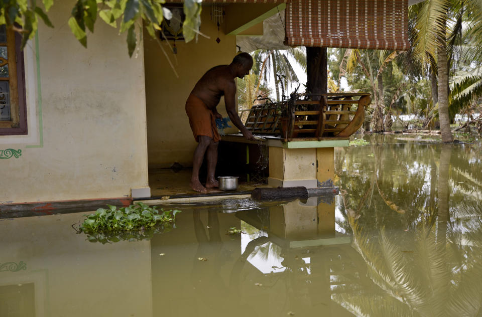 A man stands in his house amid flood waters in Kerala, India &mdash; the worst monsoon flooding in a century in the southern Indian state. (Photo: ASSOCIATED PRESS)