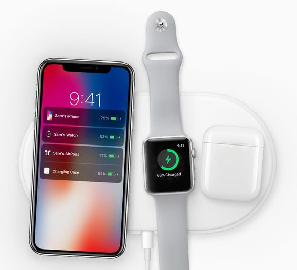 iPhone X, Apple Watch, and Airpods charging on Apple's AirPower mat.