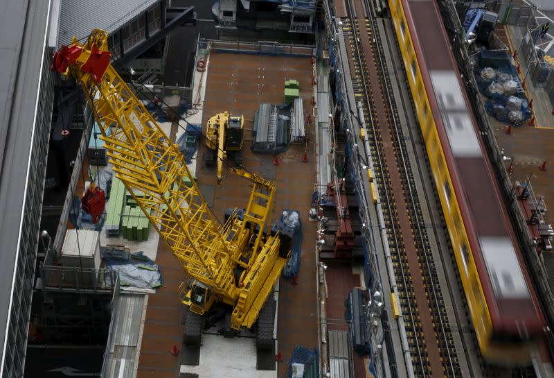 FILE PHOTO: Heavy machinery is seen next to a subway train at a construction site in Tokyo