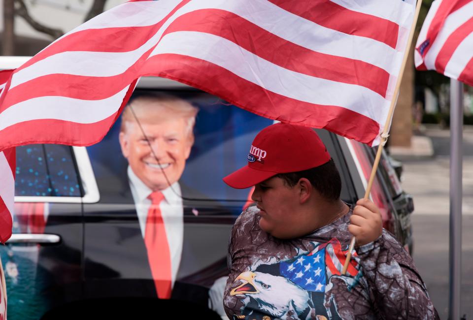 Supporters of former President Donald Trump gather near the entrance to the Trump National Doral Miami golf course for a rally to show support for Trump in Doral, Florida, USA, 12 June 2023 (EPA)