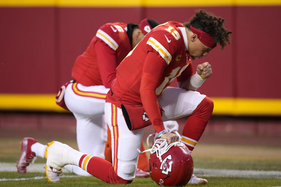 FILE - Kansas City Chiefs quarterback Patrick Mahomes prays before the NFL AFC Championship playoff football game against the Cincinnati Bengals, Sunday, Jan. 29, 2023, in Kansas City, Mo. While its Super Bowl commercial appearances are few, religion – Christianity especially – is entrenched in football culture.(AP Photo/Charlie Riedel, File)