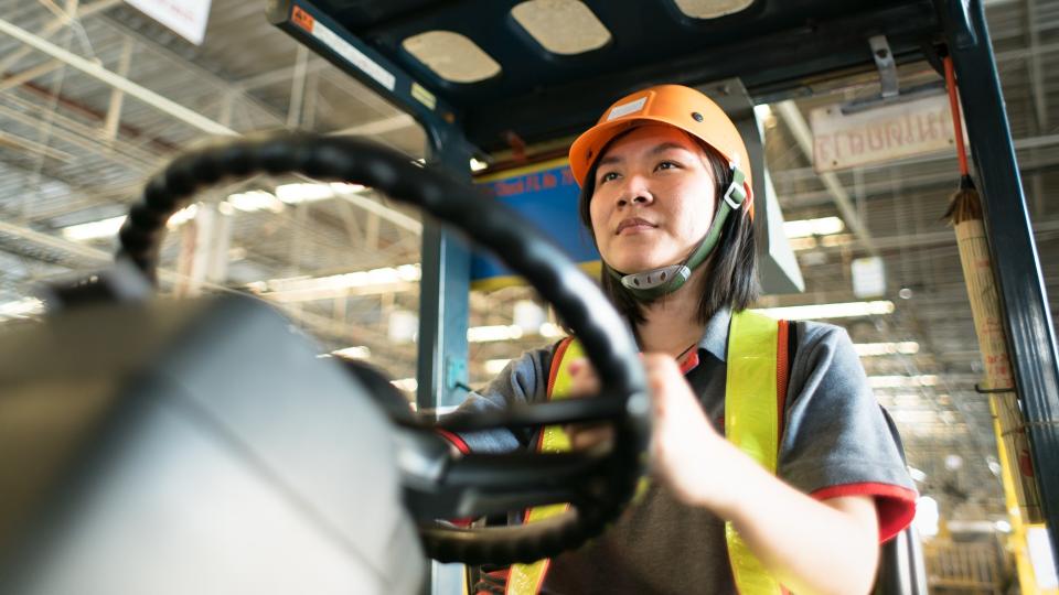 Construction worker operating equipment