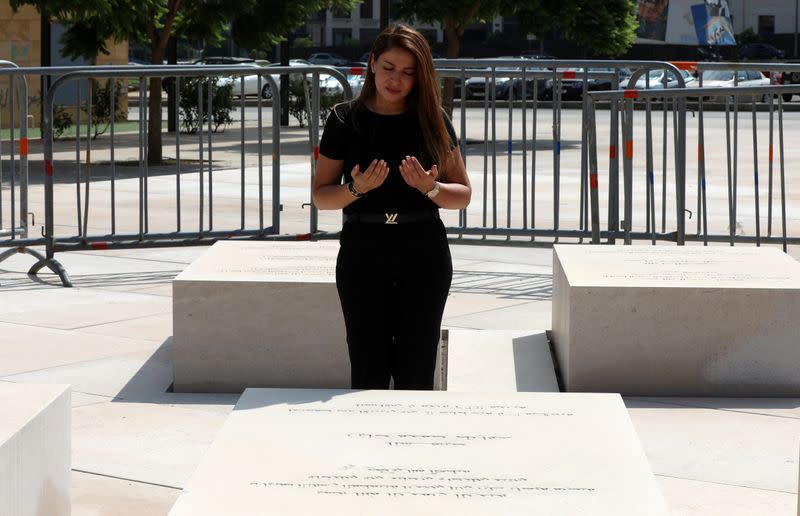 Clemence Tarraf, prays near the grave of her brother Ziad, who died during the 2005 bombing that killed former Lebanese Prime Minister Rafik al-Hariri in Beirut