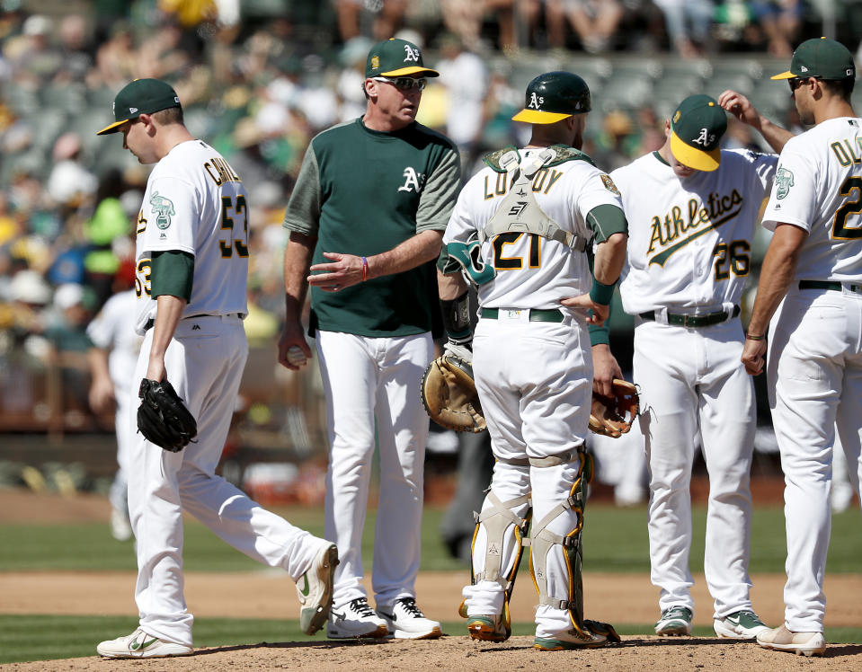 Oakland Athletics starting pitcher Trevor Cahill (53) is taken out of the game by manager Bob Melvin, second from left, against the Minnesota Twins during the fourth inning of a baseball game in Oakland, Calif., Sunday, Sept. 23, 2018. (AP Photo/Tony Avelar)