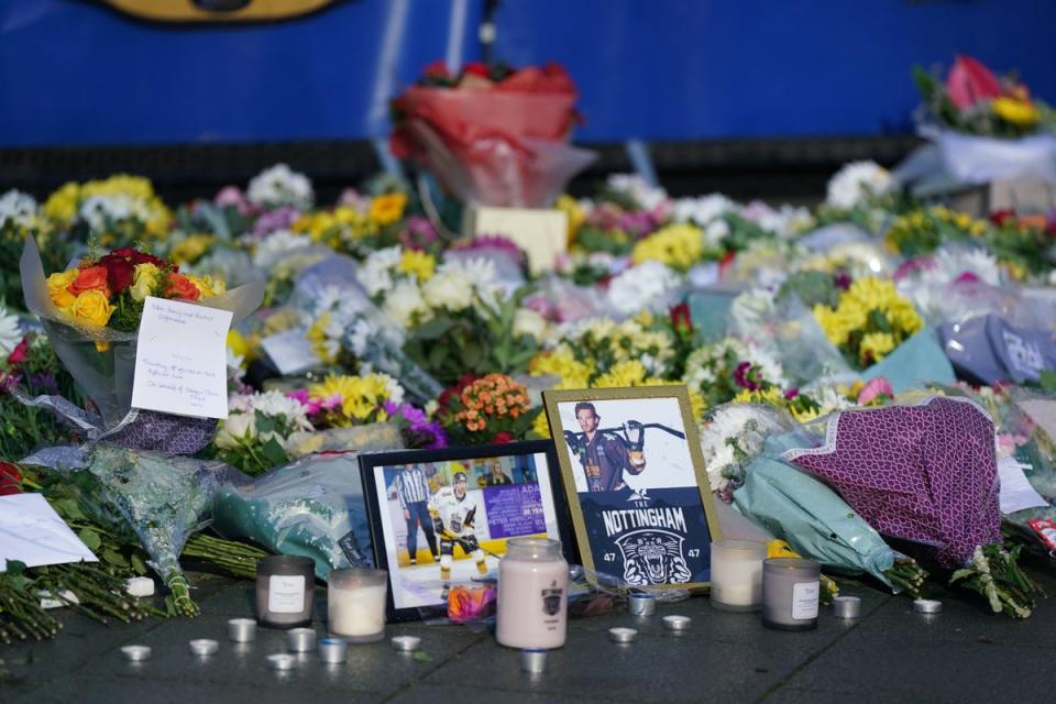 Lit candles among the flowers and messages left in tribute to Nottingham Panthers’ ice hockey player Adam Johnson outside the Motorpoint Arena in Nottingham (PA Wire)