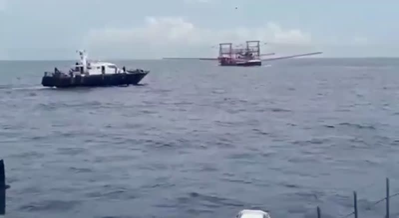 A screen grab from a video released by the Philippine Coast Guard shows a Philippine bureau of fisheries vessel (L) approaching another vessel believed to be manned by Chinese militia at Sabina Shoal in the South China Sea