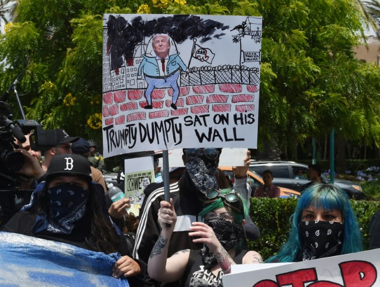 Anti-Trump protesters stand outside the Anaheim Convention Center on May 25, 2016 in California