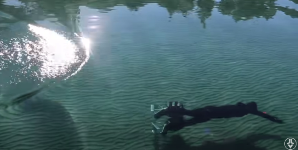 Jake Laser swims underwater using motorized boots.