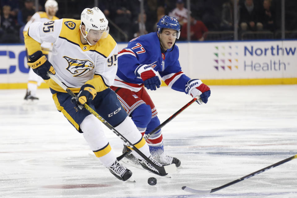 Nashville Predators left wing Filip Forsberg (9) controls the puck around New York Rangers defenseman Tony DeAngelo (77) during the first period of an NHL hockey game, Monday, Dec. 16, 2019, in New York. (AP Photo/Kathy Willens)