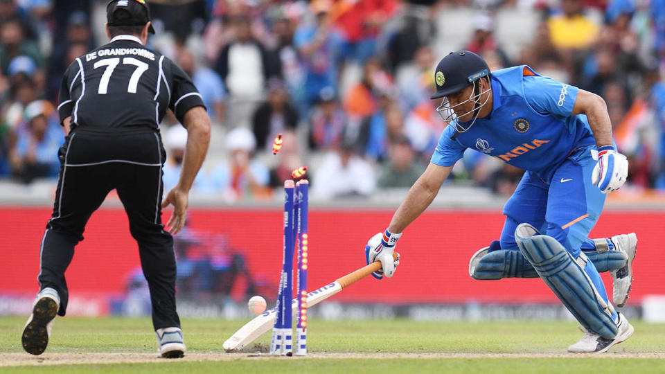 MS Dhoni was run out after an incredible throw from Martin Guptill. (Photo by OLI SCARFF/AFP/Getty Images)