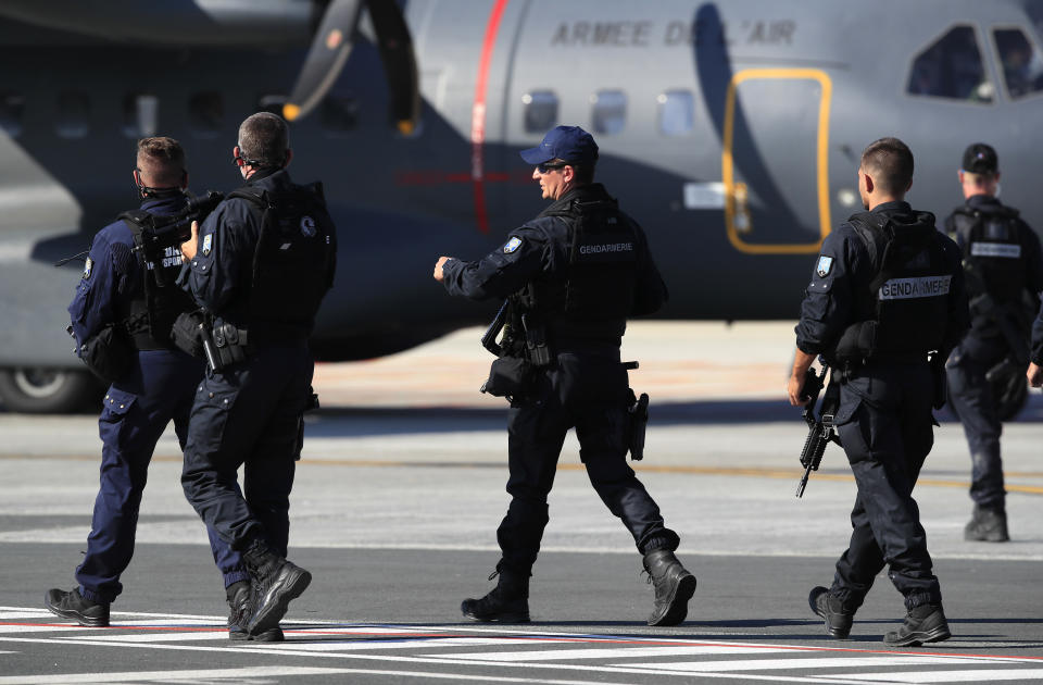 Armed police officers await the arrival of Japanese Prime Minister Shinzo Abe at the airport in Biarritz, France, for the first day of the G-7 summit, Saturday, Aug. 24, 2019. U.S. President Donald Trump and the six other leaders of the Group of Seven nations will begin meeting Saturday for three days in the southwestern French resort town of Biarritz. France holds the 2019 presidency of the G-7, which also includes Britain, Canada, Germany, Italy and Japan. (AP Photo/Peter Dejong)