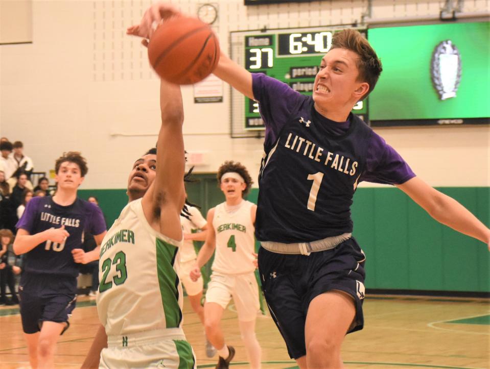 Little Falls Mountie Jack Morotti (1) races Herkimer's Dante Mollel to a long pass in the third quarter of Friday's game.