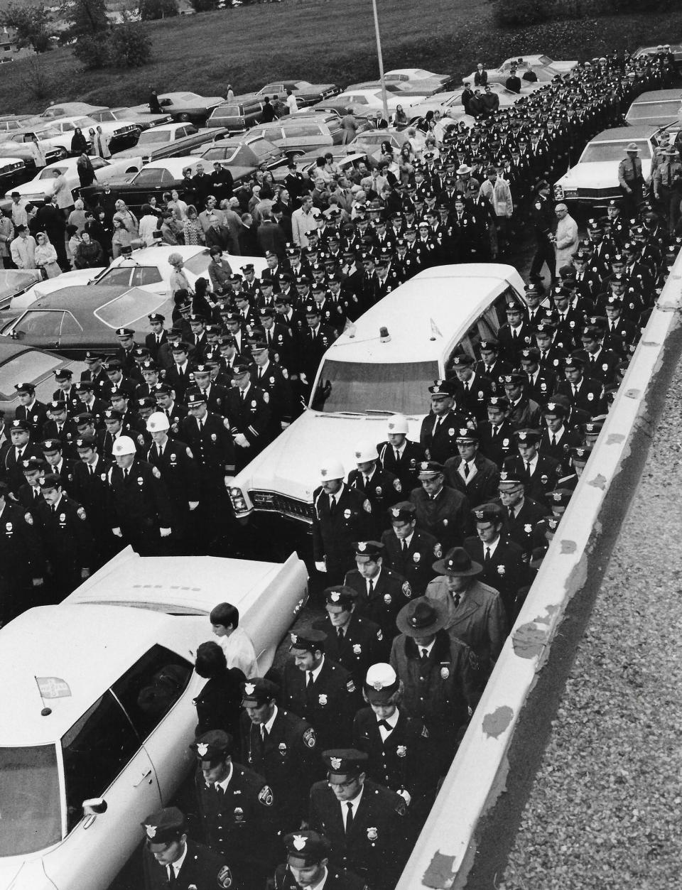 Officers pay their respects at the funeral of Akron Patrolman Stephen J. Ondas in 1972.