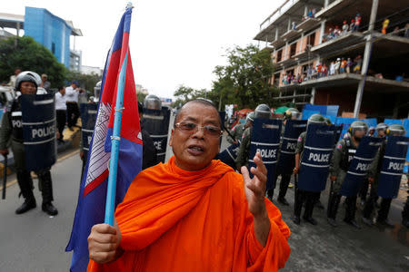 A Buddhist monk and supporter of opposition Cambodia National Rescue Party (CNRP) takes part in a march to deliver petition to the parliament and King Norodom Sihamoni to intervene in ther country's current political crisis in Phnom Penh, Cambodia May 30, 2016. REUTERS/Samrang Pring