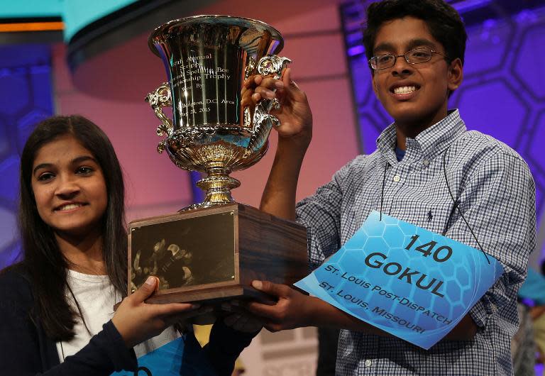 Speller Vanya Shivashankar (L) of Olathe, Kansas, and speller Gokul Venkatachalam (R) of St. Louis, Missouri, hold up the trophy after winning the 2015 Scripps National Spelling Bee May 28, 2015 in National Harbor, Maryland