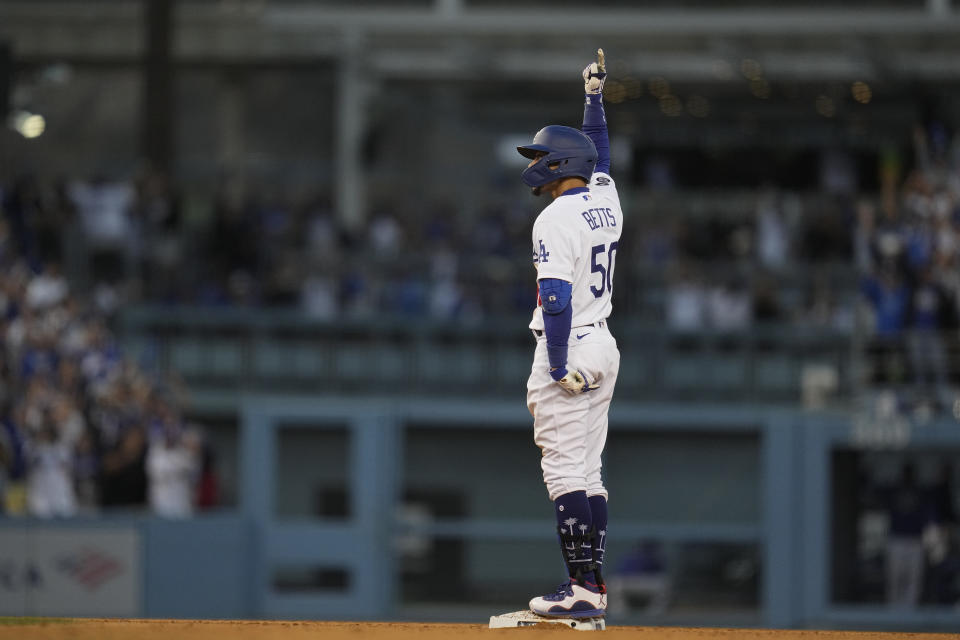 Los Angeles Dodgers' Mookie Betts celebrates his RBI double during the eighth inning against the Atlanta Braves in Game 3 of baseball's National League Championship Series Tuesday, Oct. 19, 2021, in Los Angeles. (AP Photo/Ashley Landis)