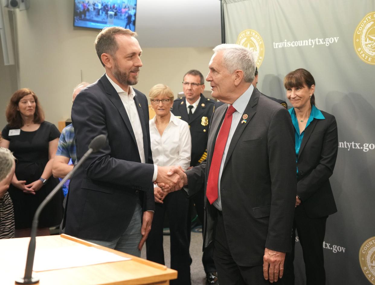 Travis County Judge Andy Brown, left, talks to U.S. Rep. Lloyd Doggett at a news conference about the nearly $51 million allocated by the county Monday.