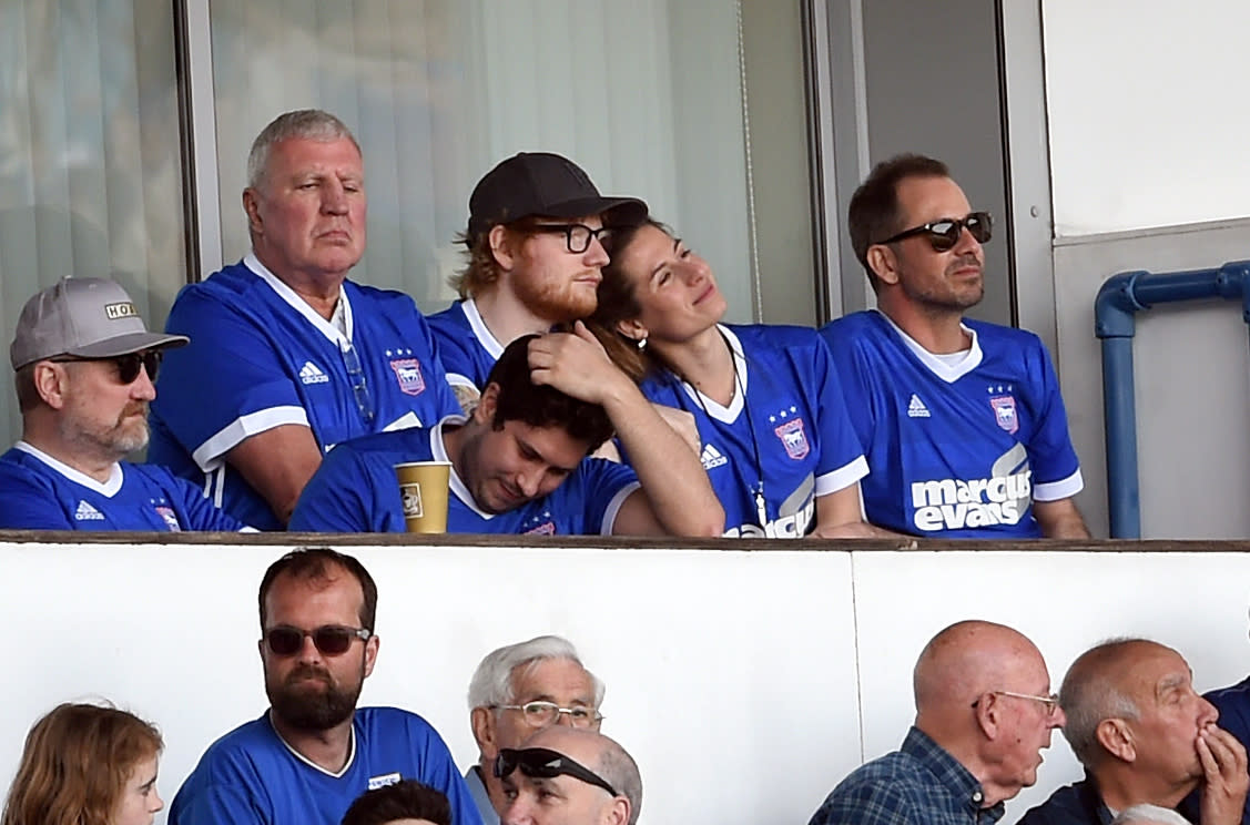 Ipswich Town fan Ed Sheeran (top row third right) and Cherry Seaborn in the stands watching the match