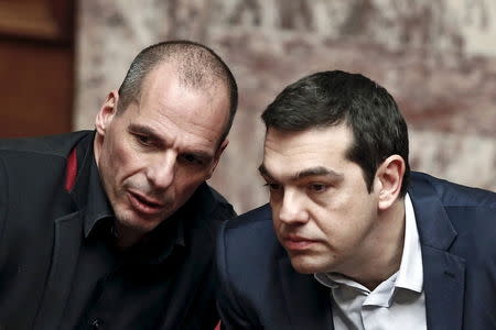 Greek Prime Minister Alexis Tsipras (R) and Finance Minister Yanis Varoufakis talk during the first round of a presidential vote at the Greek parliament in Athens, Greece in this February 18, 2015 file photo. REUTERS/Alkis Konstantinidis/Files