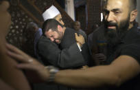 Imam Samir Abdel Bary comforts film director Osman Abu Laban, who lost four relatives in Thursday’s EgyptAir plane crash, following prayers for the dead at al Thawrah Mosque, in Cairo, May 20, 2016. (AP Photo/Amr Nabil)