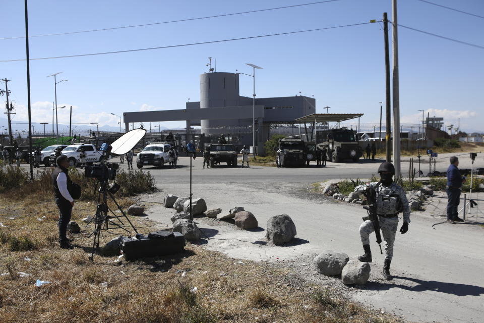 Mexican National Guard stand guard outside the Almoloya prison where Ovidio Guzman, the son of imprisoned drug lord Joaquin “El Chapo” Guzman, is being held in Villa de Almoloya de Juarez, Mexico, Friday, Jan. 6, 2023. (AP Photo/Ginnette Riquelme)