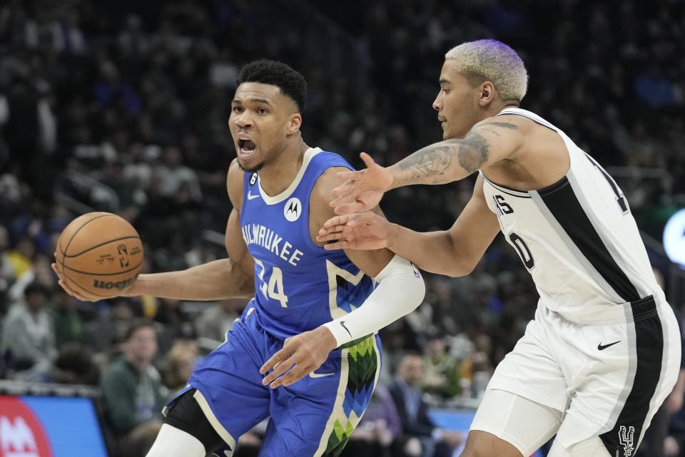 Milwaukee Bucks' Giannis Antetokounmpo drive past San Antonio Spurs' Jeremy Sochan during the second half of an NBA basketball game Wednesday, March 22, 2023, in Milwaukee. The Bucks won 130-94. (AP Photo/Morry Gash)