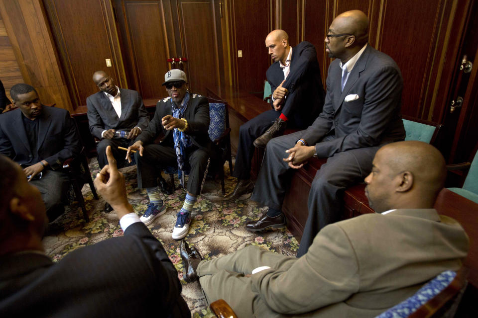 Dennis Rodman speaks with fellow US basketball players during a team meeting at a Pyongyang, North Korea hotel Tuesday, Jan. 7, 2014. Rodman came to the North Korean capital with a team of USA basketball stars for an exhibition game on Jan. 8, the birthday of North Korean leader Kim Jong Un. Clockwise from bottom left are Charles D. Smith, unidentified, Cliff Robinson, Rodman, Doug Christie, Vin Baker, and unidentified. (AP Photo/David Guttenfelder)