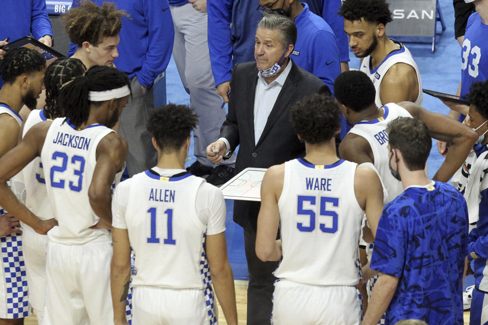 Kentucky coach John Calipari, middle, talks with players during a timeout in the second half of an NCAA college basketball game against LSU in Lexington, Ky., Saturday, Jan. 23, 2021. (AP Photo/James Crisp)