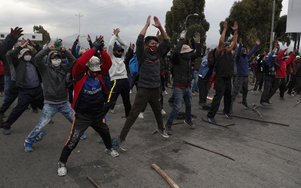 Demonstrators wearing face masks amid the COVID-19 pandemic, protest against the postponement of the presidential election in El Alto, Bolivia, Tuesday, Aug. 11, 2020. Citing the ongoing new coronavirus pandemic, Bolivia's highest electoral authority delayed presidential elections from Sept. 6 to Oct. 18, the third time the vote has been delayed. (AP Photo/Juan Karita)