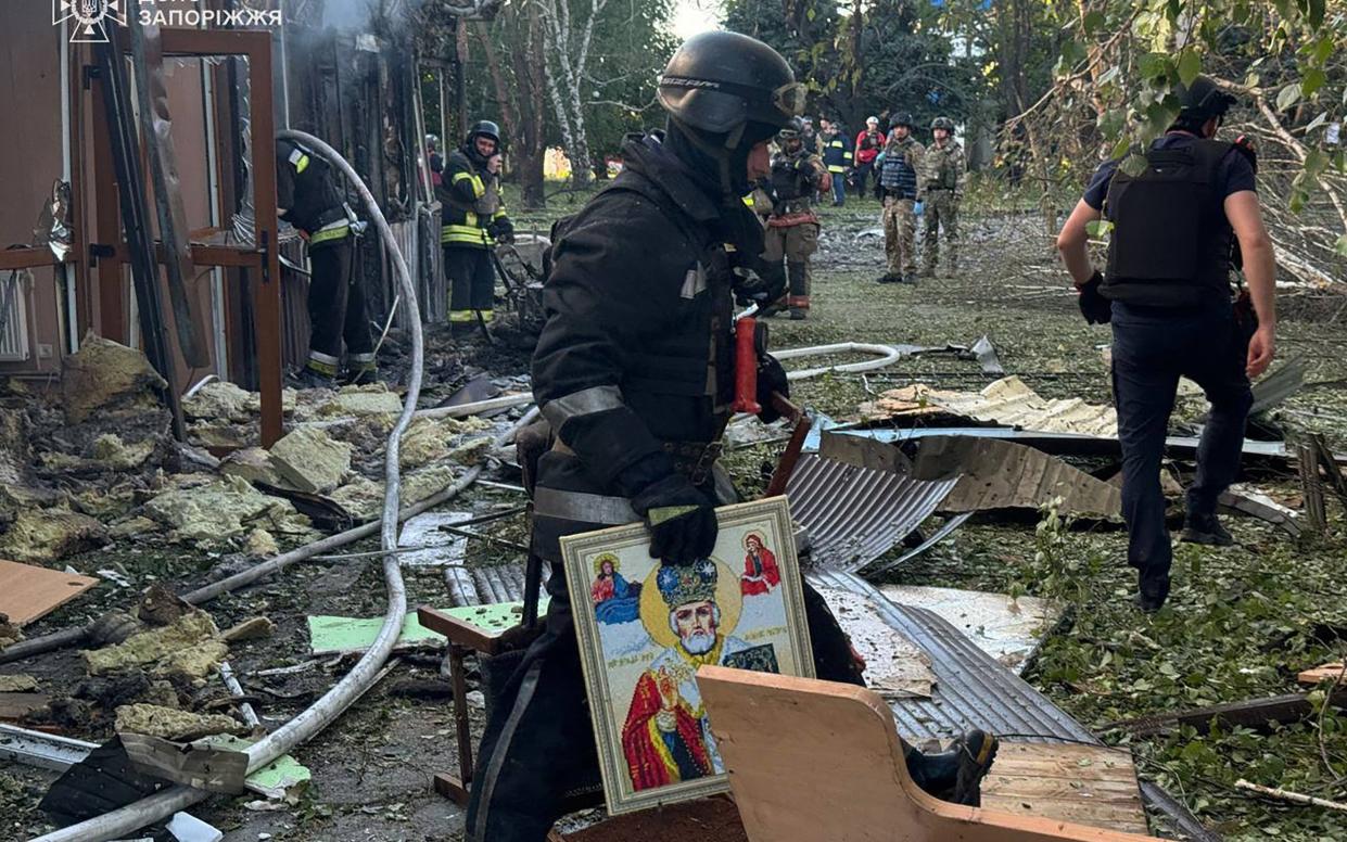 Firefighters at the site of a Russian strike in the centre of Vilniansk in the Zaporizhzhia region