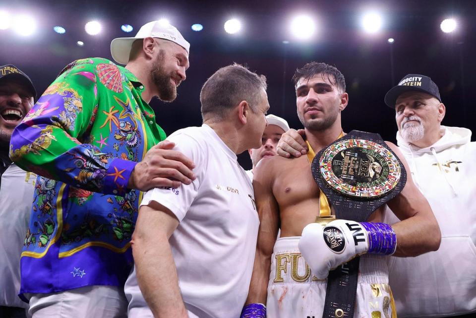 Fury with half-brother Tyson (far left) and father John (far right) last night (Getty Images)