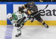 Dallas Stars' Mattias Janmark (13) is checked by Vegas Golden Knights' Reilly Smith (19) during the first period of Game 2 of the NHL hockey Western Conference final, Tuesday, Sept. 8, 2020, in Edmonton, Alberta. (Jason Franson/The Canadian Press via AP)